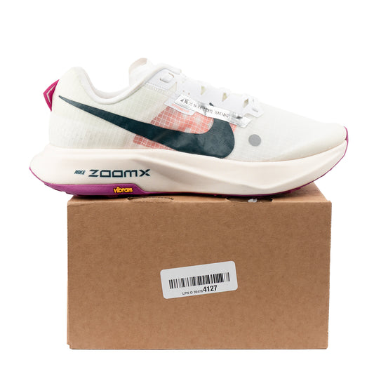 Nike Ultrafly Trail racing shoes in white and orange — angled pair